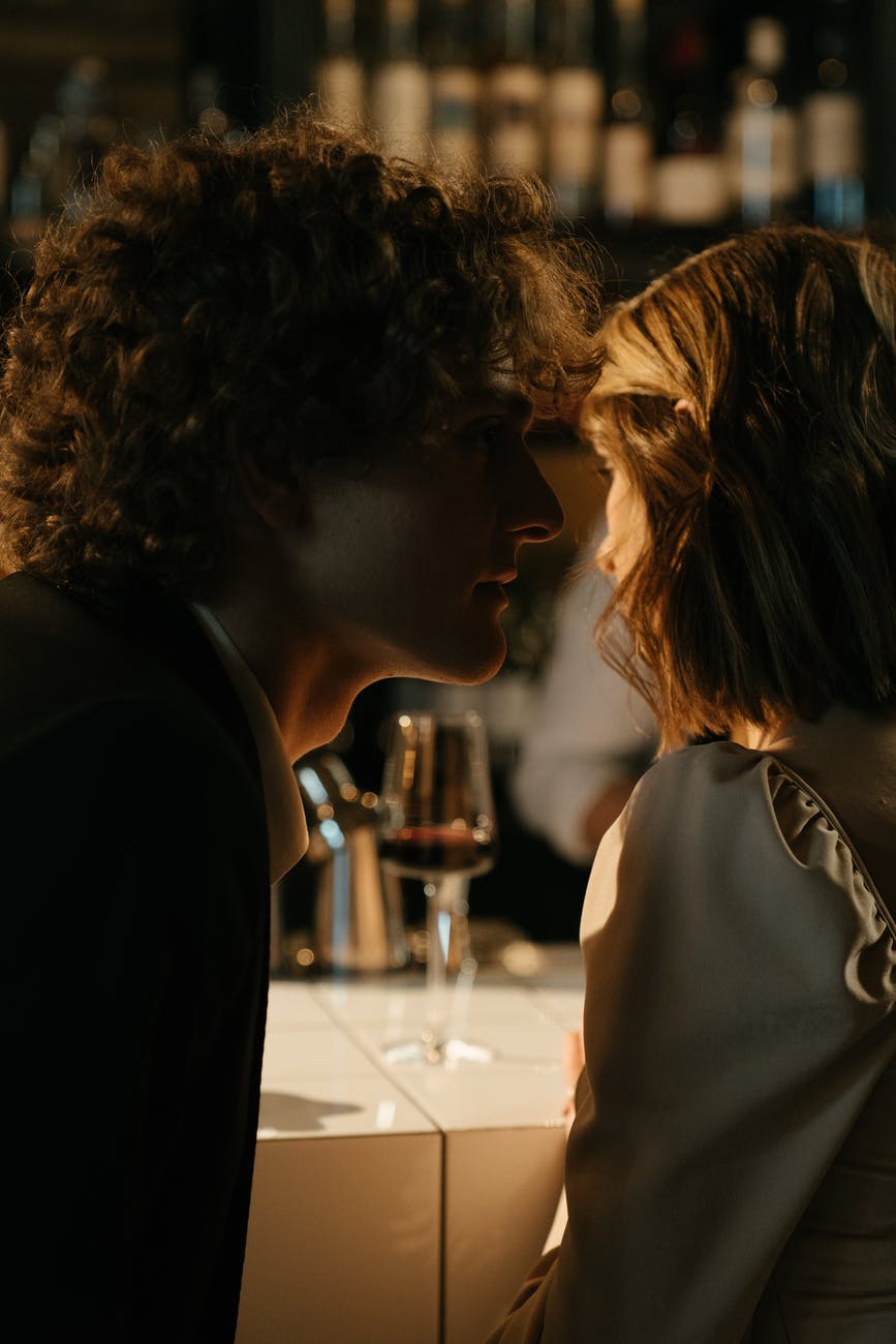 woman in black shirt sitting beside man in black shirt