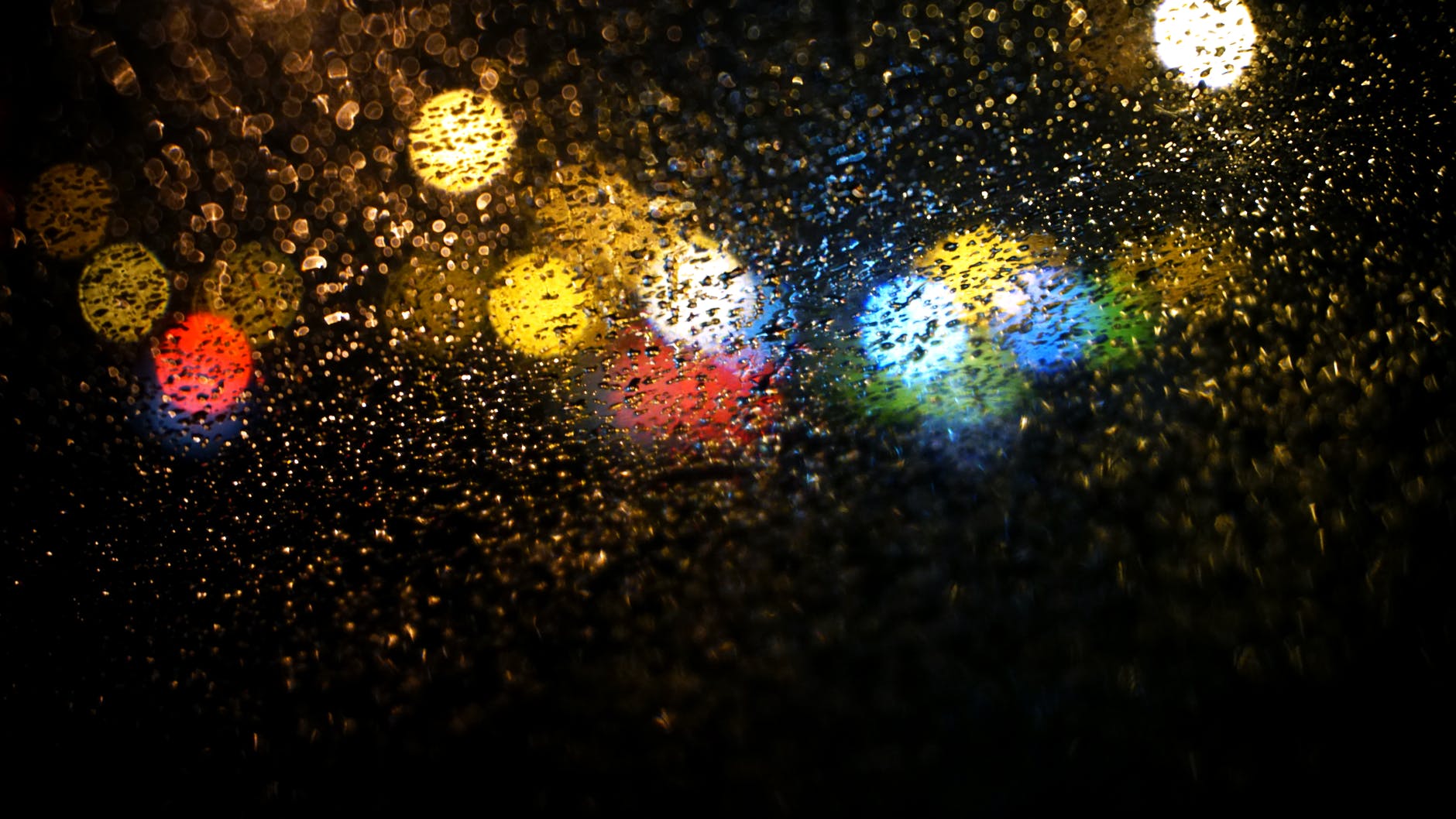 raindrops on road seen through car window